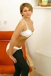 Smiling Claire O takes off her black blouse increased by stockings then removes her undies
