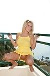 Bonny obese titted blonde Charlie Lynn lifts her yellow clothes in all directions and shows her bald pussy