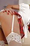 Crabby schoolgirl Crystal R striking tempting poses not far from skirt and stockings
