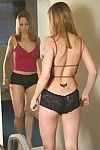 Inexpert darling Laura puts the brush panties and stockings on in the mirror image