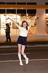 Skinny brunette teen Audrey Star posing in a skimpy skirt outdoors
