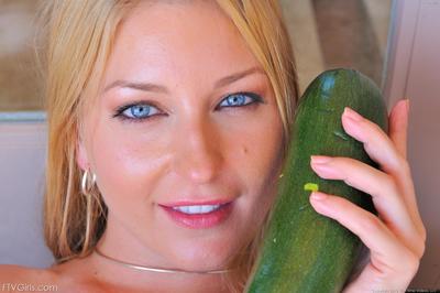 Busty blue-eyed blonde Avy Scott has fun masturbating with vegetables and water hose