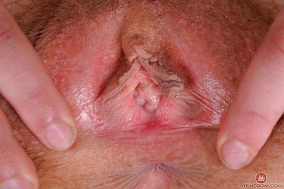 Older redhead Leona spreading hairy pink pussy after slipping thong off ass