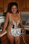 Granny Ivee showing off tattoos and shaved mature vagina in kitchen