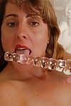 Granny sucks her tasty glass dildo and fucks hot pink pussy on cam