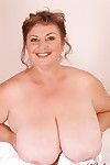 Mature plumper with huge saggy jugs and hairy cooter posing on the bed
