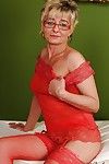Naughty granny in glasses taking off her lingerie and spreading her legs