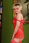 Naughty granny in glasses taking off her lingerie and spreading her legs