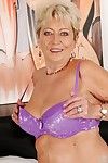 Chubby granny with shaggy twat taking off her lingerie on the bed