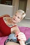 Short haired amateur granny with tattooed rack gives a handjob
