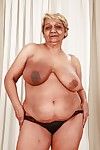 Fatty granny with big flabby boobs stripping off her suit and lingerie
