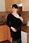 Naughty brunette granny with flabby boobs stripping in the kitchen