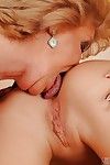 Big busted granny and her teen friend are into passionate lesbian sex