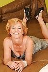 Naughty granny on high heels stripping off her dress and spreading her legs