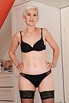 Well toned granny in nylon stockings slipping off her clothes