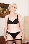Slim granny in stockings slipping off her dress and lingerie