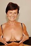 Short haired granny in stockings stripping off her dress and lingerie