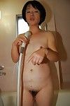 Asian granny Tomoe Nakamachi stripping and taking hairy cunt to shower