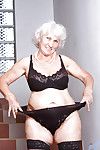 Fat granny in black hold up stockings squeezing a sex toy between her puffy tits