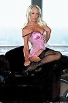 Busty blonde MILF Bridgette Kerkove wears sexy black stockings ad flaunts her gorgeous body