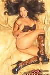 Busty round assed latina Nina Mercedez poses in boots and black lingerie