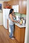 Dark haired latina milf Isis Love with big melons and bald pussy gets nude in the kitchen