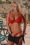 Blonde MILF Holly Halston with huge boobs and shaved snatch takes off her red lingerie outdoors