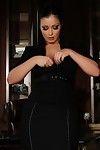 Curvaceous big racked brunette Aria Giovanni strips out of her black suit