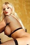 Blonde milf beauty Brittany Andrews in fishnet top and stockings shows off her big melons