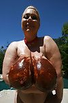 Busty mature babe Samantha 38G playing with her melons outdoor