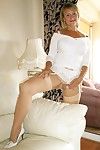 Old lady in white stockings and lingerie spreading and masturbating on the couch