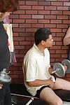 Fat older redhead Adrienne sucks and fucks two cocks in weight room