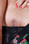 Aged brunette Jacky Fay-Lynn revealing pierced nipple and twat while disrobing