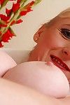 Busty aged blonde Monik folding back labia lips of pink vagina in heels