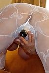 Older housewife Sandra Otterson releasing knockers from see thru stocking