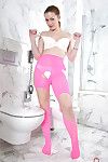 Older solo model Mischelle removing pink pantyhose from ass in bathroom