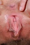 Older hirsute lady Leona spreading pink pussy for clitoral stimulation
