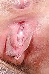 Older babe Leona revealing hairy pink twat and clitoris after panty removal