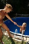 Two old and teen lesbians making out at the pool