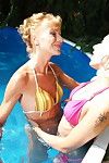 Two old and teen lesbians making out at the pool