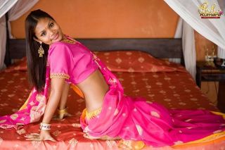 Unlighted asha kumara takes withdraw beautiful india sari on bed