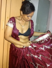 Clothed Indian woman strips to their way disgraceful bra with an increment of underskirt